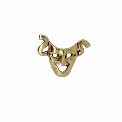 Gold-colored mask pin on a white background