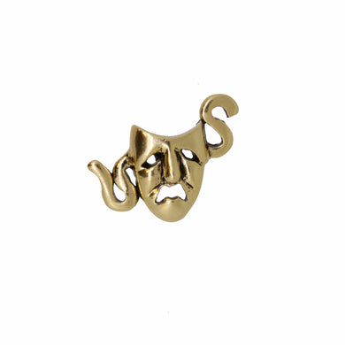 Gold theater mask pin on a white background