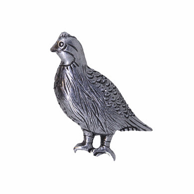 Metallic quail shaped lapel pin on a white background
