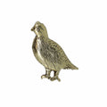 Gold bird pin on a white background
